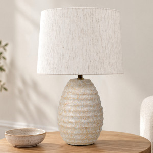 Lopez rippled ceramic table lamp with a linen shade on a timber table beside a speckled bowl