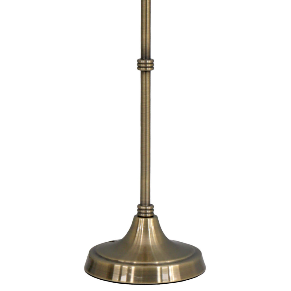 Close-up of the Claudia lamp’s antique gold metal stem, decorative rings and round pedestal base