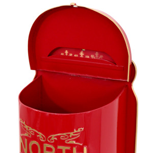 Close-up of red metal Christmas postbox with hinged lid open, showing the interior and letter slot