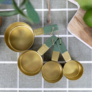 Set 4 Edwin Gold Measuring Cups, a drinkware piece designed for serving beverages at the table