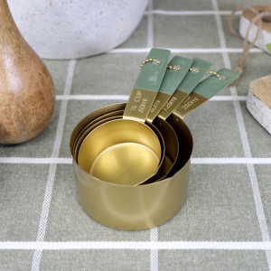 Set 4 Edwin Gold Measuring Cups, a practical vessel for drinks with decorative tabletop appeal