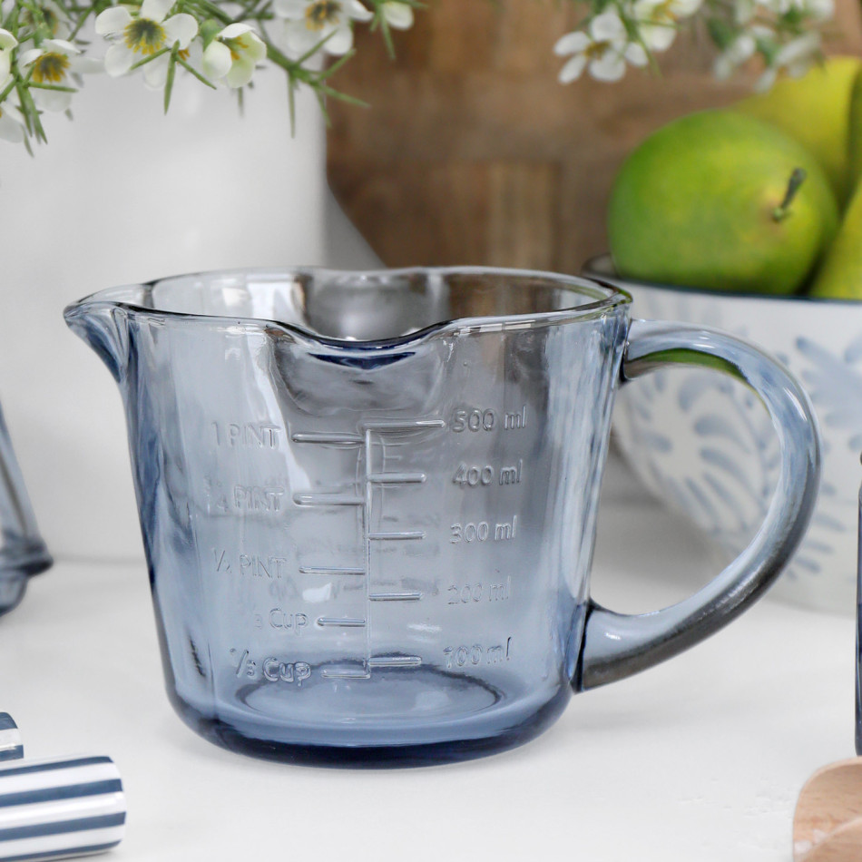 Heritage Blue Glass Measuring Jug styled on a white kitchen bench with coordinating blue glassware