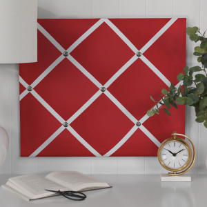 Red fabric memo board showing the decorative ribbon grid and antique nickel buttons