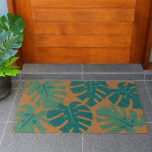 Green palm leaf coir doormat presented at an inviting covered entrance