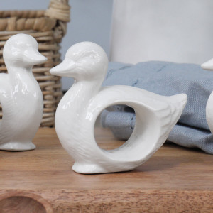 White glazed ceramic napkin ring with sculpted duckling design