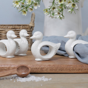 Set of four white ceramic duckling napkin rings