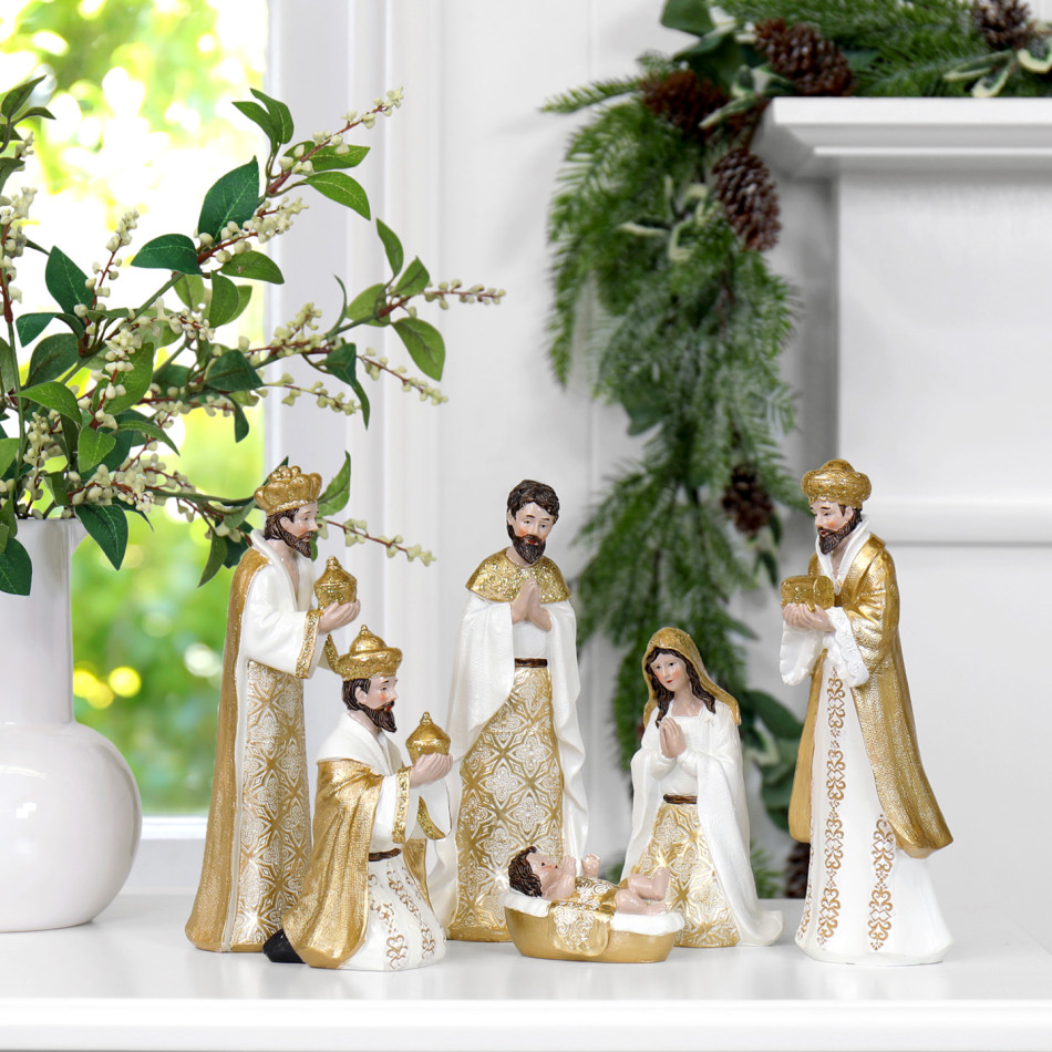 Gold and white resin Nativity figurines arranged as a Christmas display