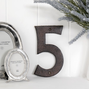 Close view of the antique brown finish on the cast iron house number 5