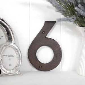 Close view of the antique brown finish on the cast iron house number 6
