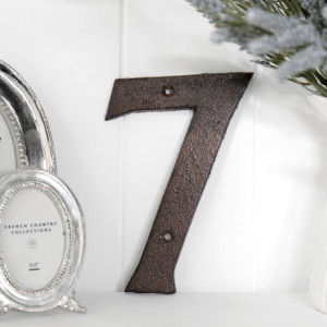 Close view of the antique brown finish on the cast iron house number 7