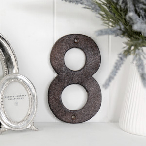 Close view of the antique brown finish on the cast iron house number 8