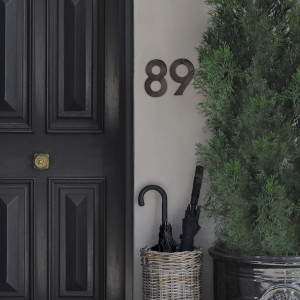 Kew vintage house number 8 and 9 mounted to a wall
