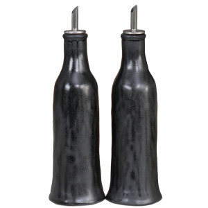 Two tall black reactive-glaze oil and vinegar bottles with metal pourers on a white background.