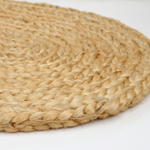 Close view of the natural fibres and plaited pattern on the oval jute mat