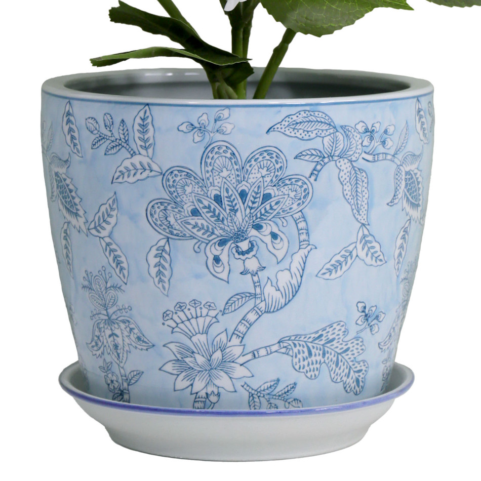 Close-up of the Swanson pot’s handpainted blue flowers and leaves, with hydrangea stems above the rim