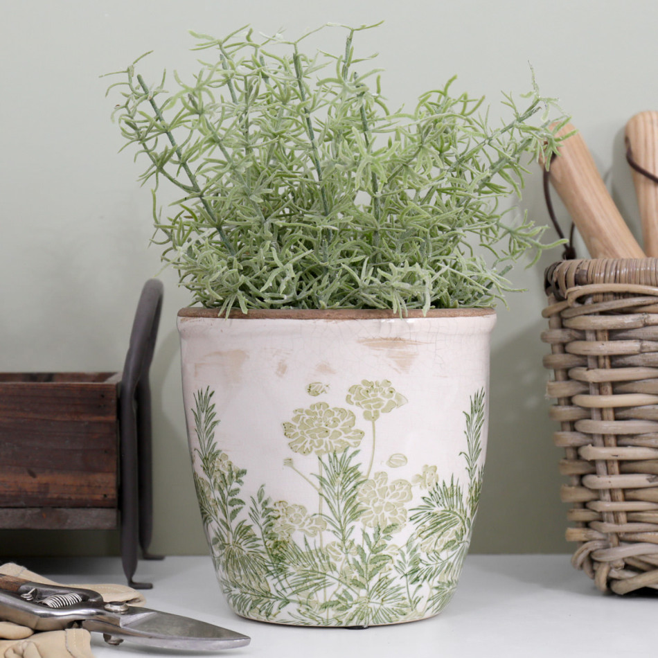 Large Glendale Rounded Plant Pot with soft green foliage on a bench beside a wooden caddy and woven tool basket
