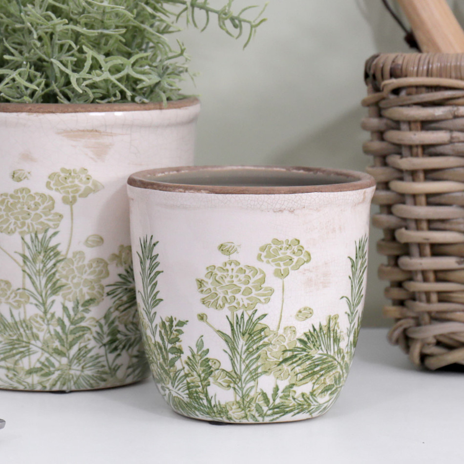 Close-up of the Small Glendale Rounded Plant Pot beside the larger matching pot and a woven basket