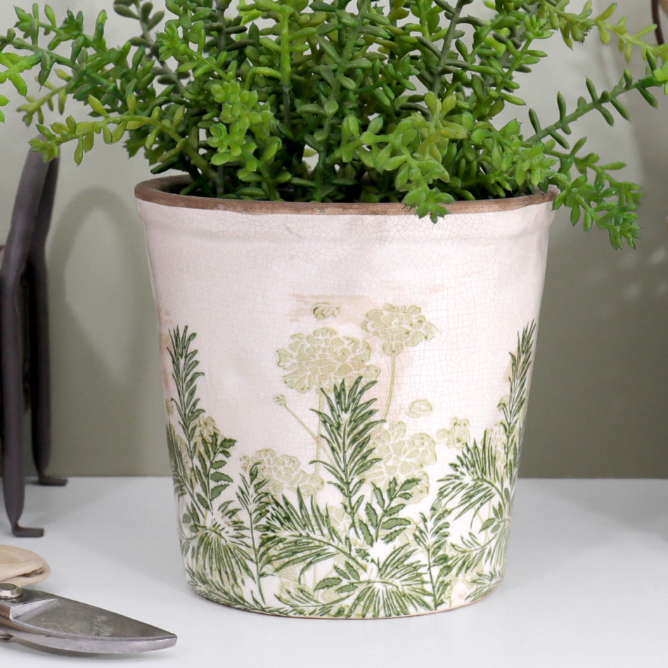 Close-up of the Small Glendale plant pot with green foliage, botanical decoration and vintage crackle glaze