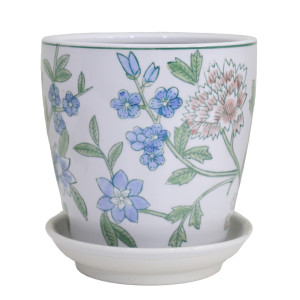 Small white ceramic plant pot with pink and blue flowers, green leaves, a green rim and matching saucer