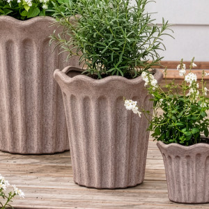 Medium sand terracotta fluted plant pot with rosemary between matching large and small pots
