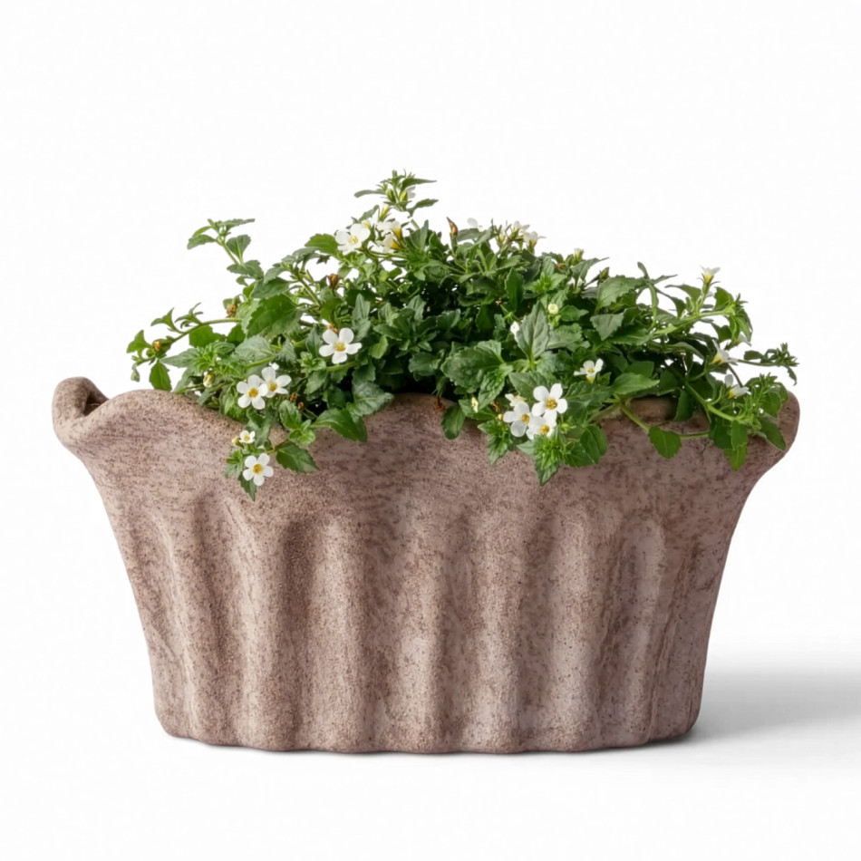 Front view of small fluted sand terracotta planter filled with white flowers