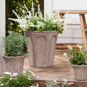 Large Varenna arch plant pot with white flowers styled among coordinating planters