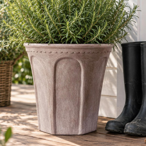 Large sand terracotta Varenna plant pot filled with white flowers beside a Tivoli planter