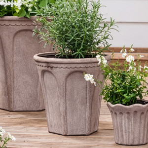 Medium Varenna arch plant pot with rosemary between coordinating sand terracotta planters