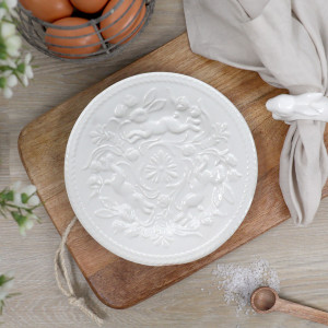White ceramic plate with an embossed rabbit, floral details and beaded rim