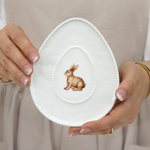 White oval ceramic trinket plate with a seated rabbit illustration and beaded edge
