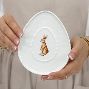 White oval ceramic trinket plate with an upright rabbit illustration and raised beaded border