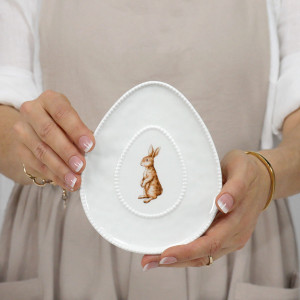 Oval rabbit trinket dish with a decorative beaded edge and shallow profile