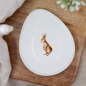 Close view of white oval ceramic trinket dish with an upright rabbit illustration