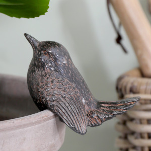 1.jpg	Close-up of Kendall Bird I resin pot hanger with a vintage brown finish and detailed wing feathers on a pale pot