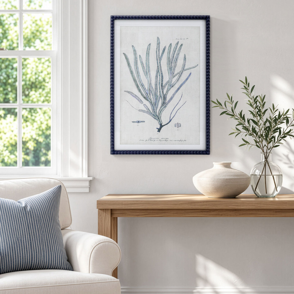 Blue Reef Whip Coral Framed Print in a coastal room with a timber console, white armchair and blue striped cushion