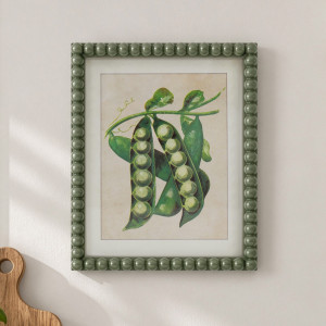 Close view of the Cottage Garden Green Peas print with open pea pods in a beaded green frame