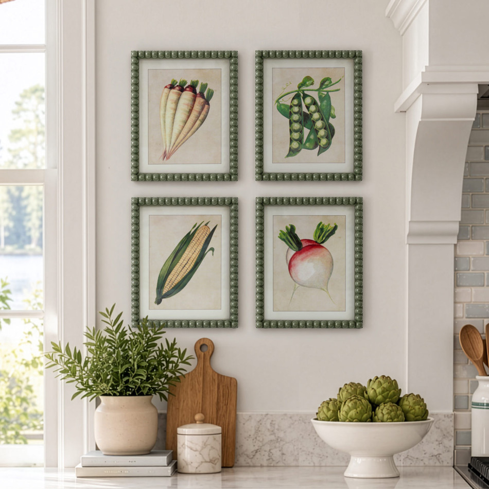 Four vegetable botanical prints in beaded green frames above a kitchen bench, with Sweetcorn at bottom left