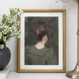 Rosina vintage portrait print in a gold-toned frame styled on a white console beside flowers and a brass lamp.