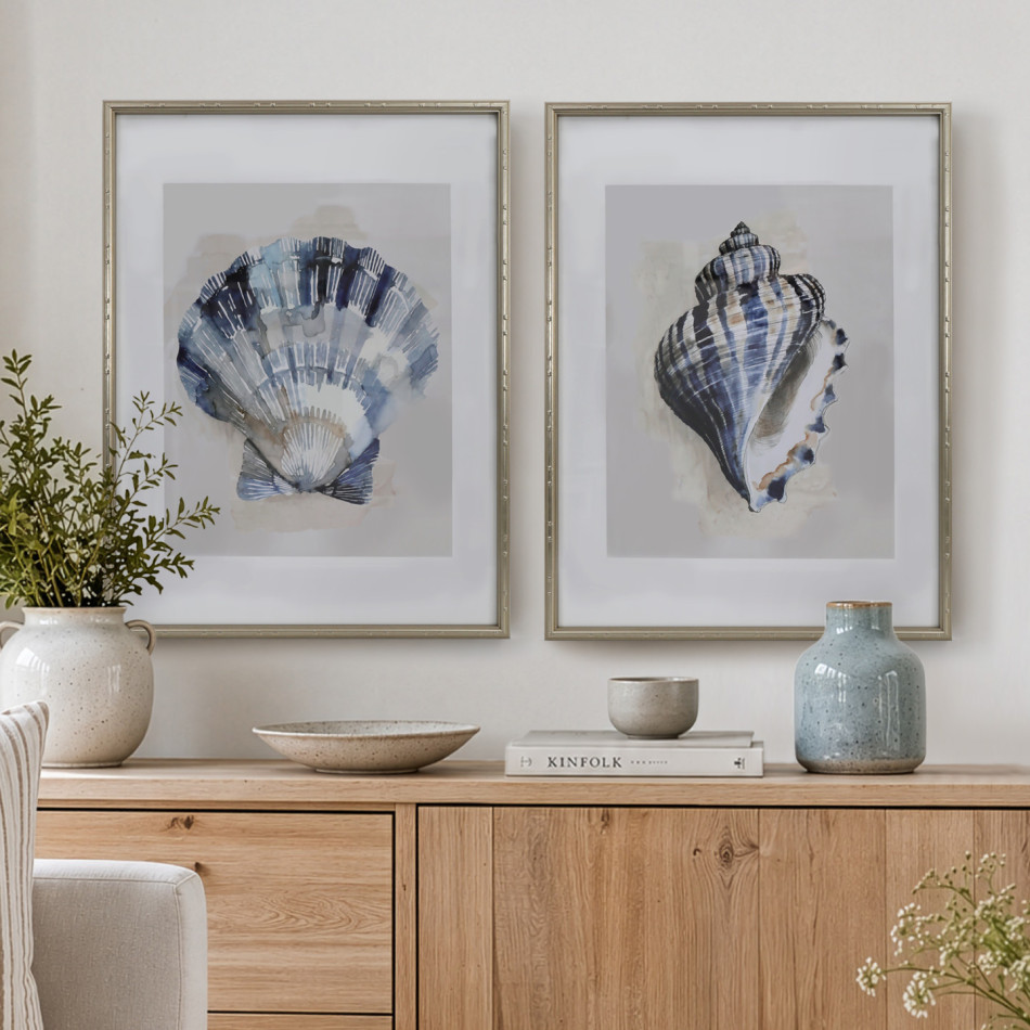 Arcadia Scallop and Turban shell prints in champagne gold frames above a timber sideboard with vases