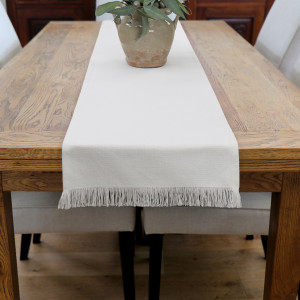 White Bronte Fringe Table Runner, a freestanding table suited to displaying useful or decorative items