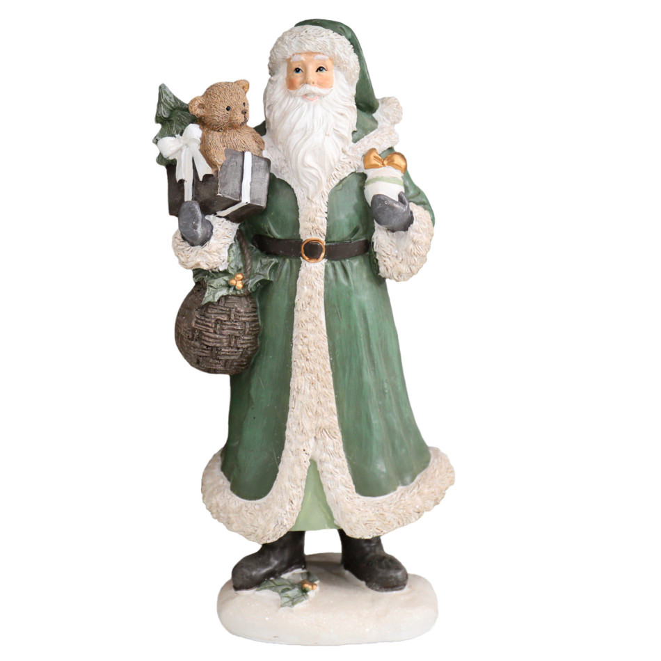Resin Santa in a green coat with cream trim, holding a teddy bear and gifts against a white background