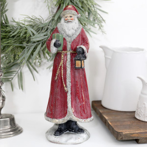 Woodland Father Christmas with Lantern displayed beside a white jug and green wreath on a white surface