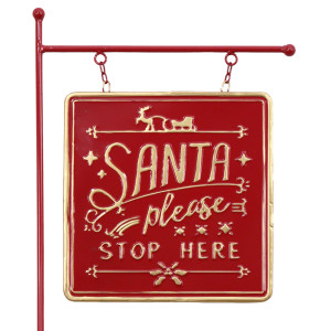 Close-up of gold Santa please stop here lettering, reindeer and sleigh on a red metal hanging sign