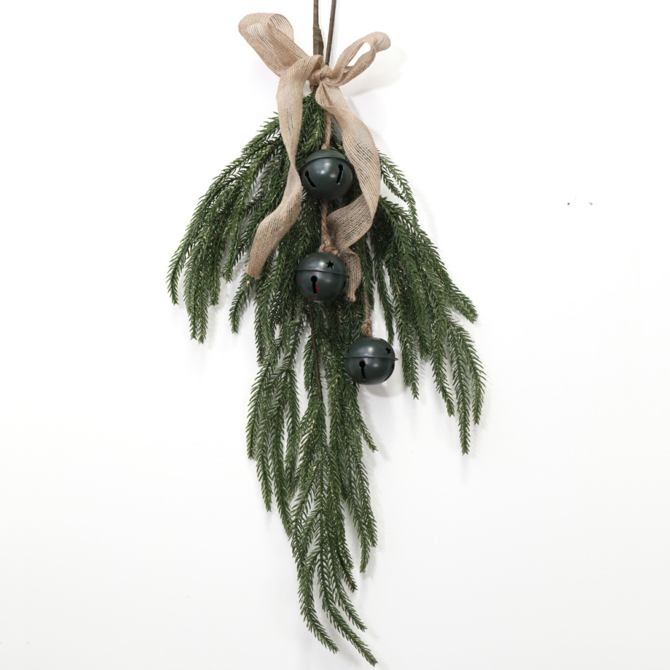 Green bell Christmas swag showing trailing foliage, cutout metal bells, a hessian bow and hanging loop on a white background.
