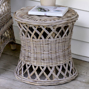 Clifton round grey-brown rattan side table with book and vase on a covered verandah