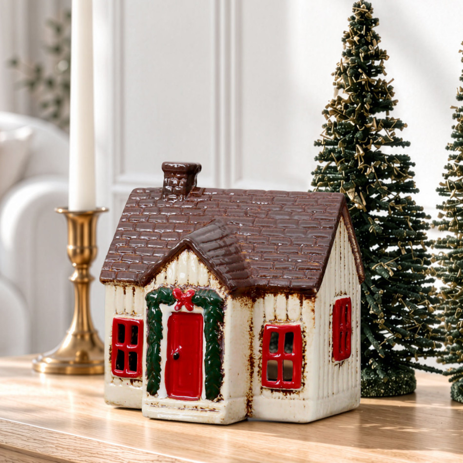 Cream Christmas cottage tealight holder showing red window frames, garland doorway and chimney