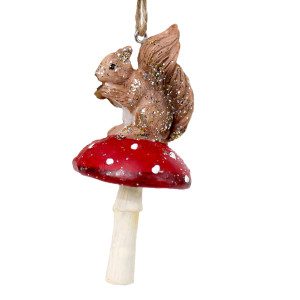 Resin squirrel on a red and white spotted toadstool with a cream stem against a white background