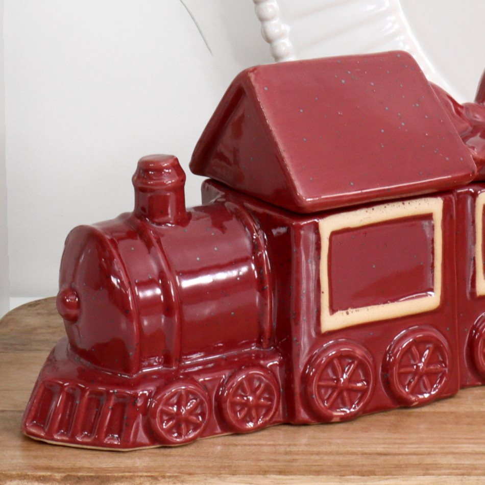 Close-up of the red ceramic locomotive showing its chimney, moulded wheels, cream panel border and speckled finish.