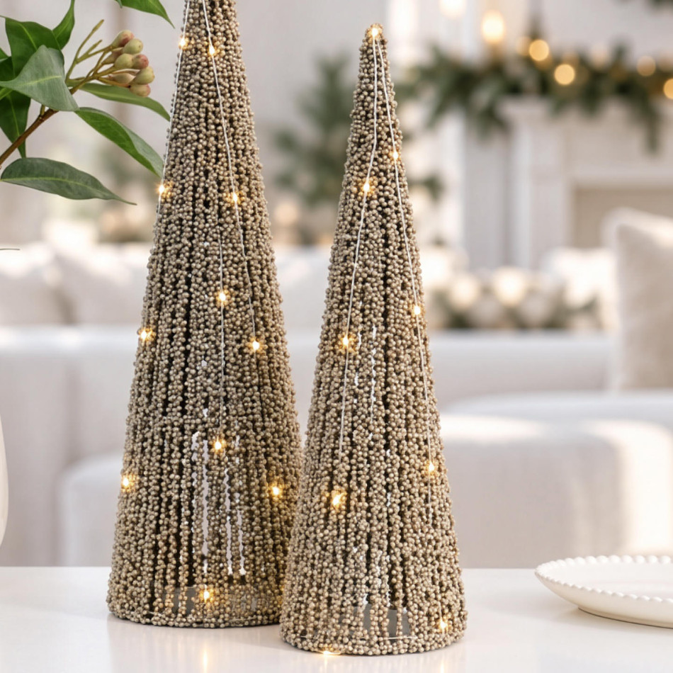 Small gold beaded LED Christmas tree beside the matching larger size on a white table