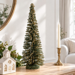 Large Winter Noel green Christmas tree beside a candle and christmas decorations